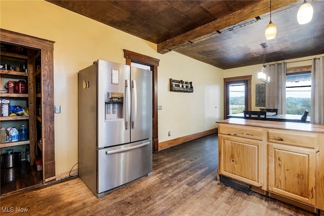 kitchen featuring beamed ceiling, dark wood-type flooring, hanging light fixtures, light brown cabinets, and stainless steel fridge