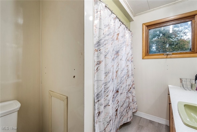 bathroom featuring ornamental molding, vanity, toilet, and hardwood / wood-style flooring