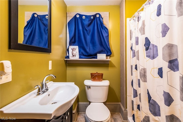 bathroom with walk in shower, vanity, toilet, and tile patterned floors