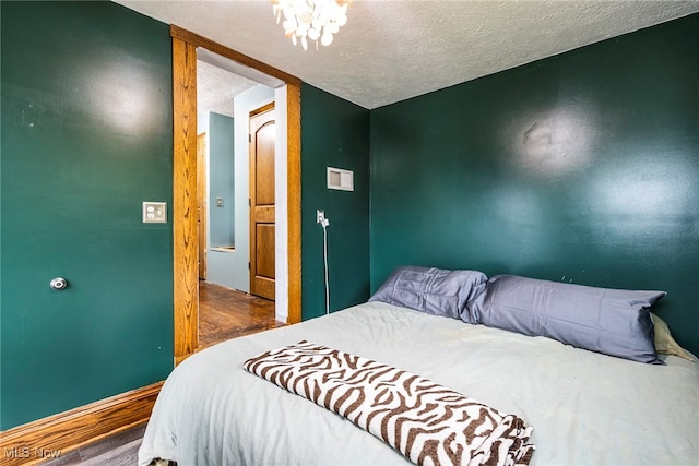 bedroom featuring wood-type flooring and a textured ceiling