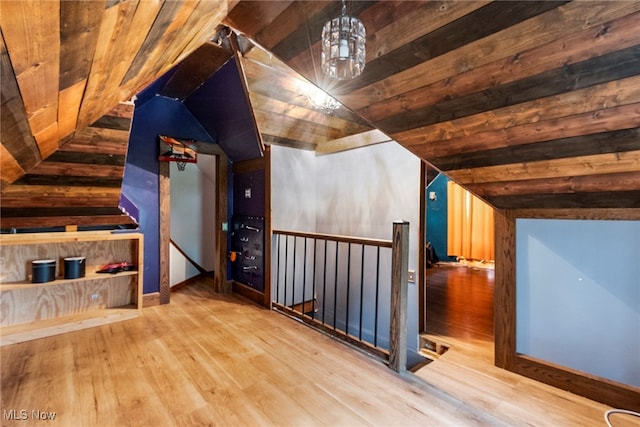 bonus room featuring wooden ceiling, wood-type flooring, vaulted ceiling, and a notable chandelier