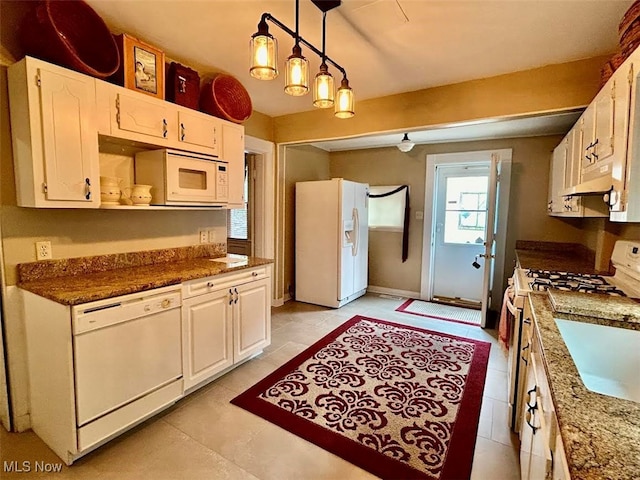 kitchen with light tile patterned flooring, pendant lighting, white appliances, and white cabinetry