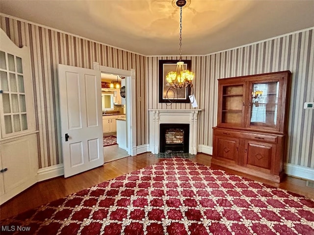 unfurnished room featuring a notable chandelier and hardwood / wood-style flooring