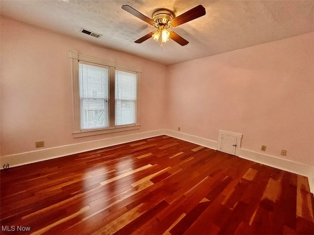 empty room featuring hardwood / wood-style floors, a textured ceiling, and ceiling fan