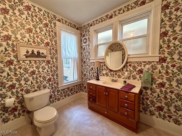 bathroom with crown molding, vanity, and toilet