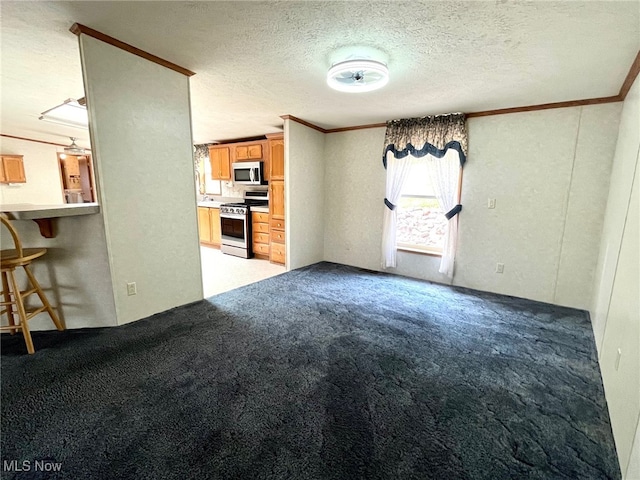 unfurnished living room with a textured ceiling, light colored carpet, and crown molding