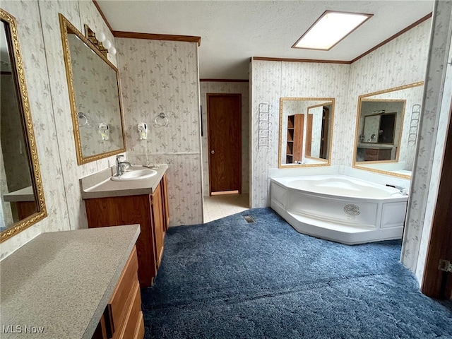 bathroom with vanity, crown molding, a textured ceiling, and a tub