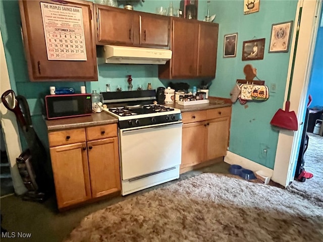 kitchen featuring white range with gas stovetop