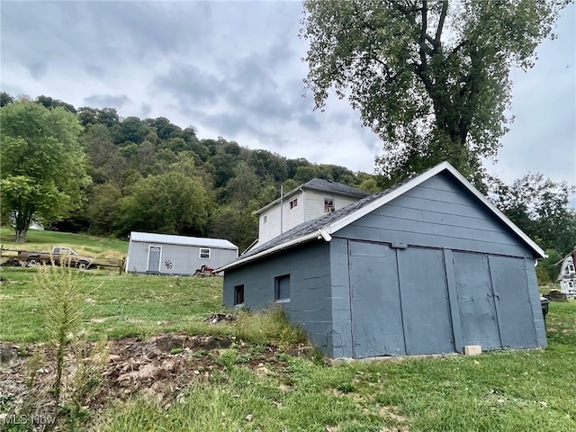 view of outbuilding with a lawn