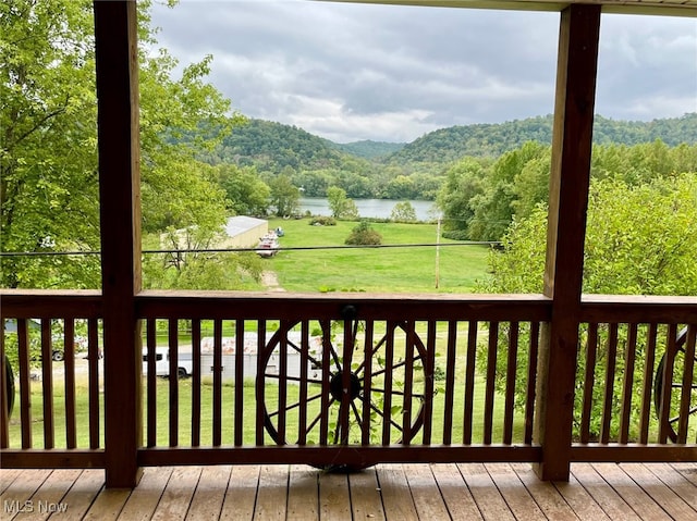 deck with a water and mountain view