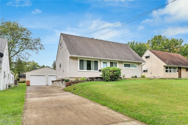 view of front of property featuring a front yard, a garage, and an outdoor structure