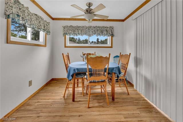 dining room with light hardwood / wood-style flooring, ceiling fan, and ornamental molding