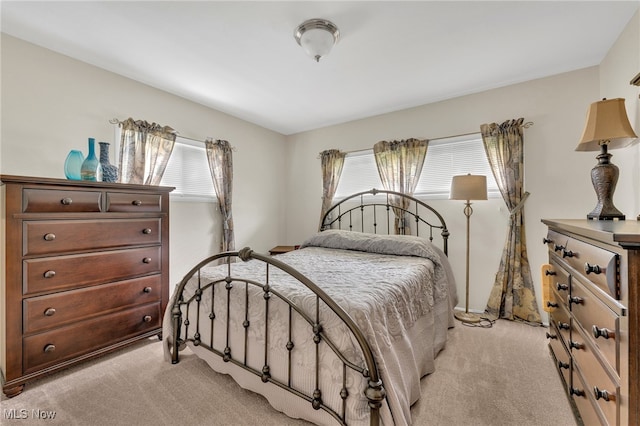 carpeted bedroom with multiple windows