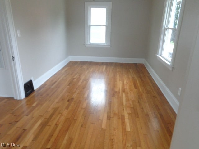 unfurnished room with light hardwood / wood-style flooring and plenty of natural light