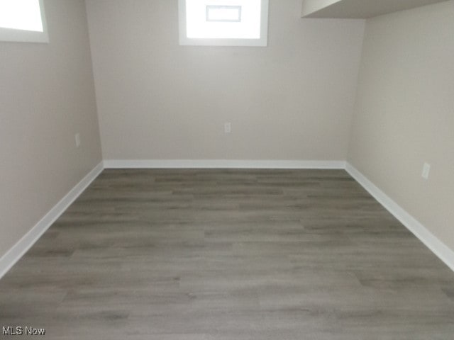 basement with dark hardwood / wood-style flooring