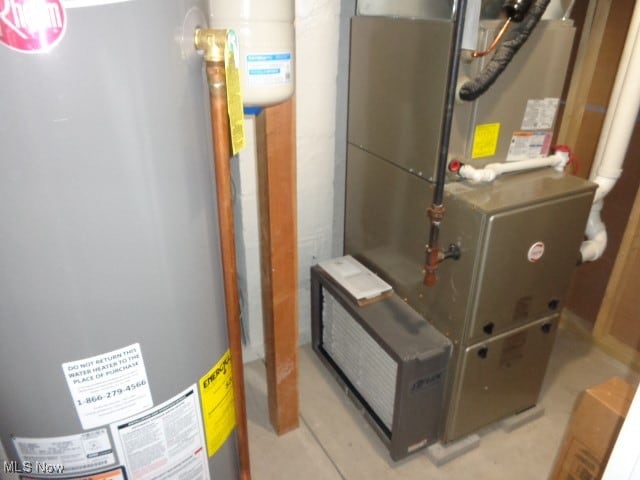 utility room with gas water heater and heating unit