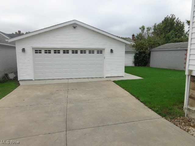 garage featuring a lawn