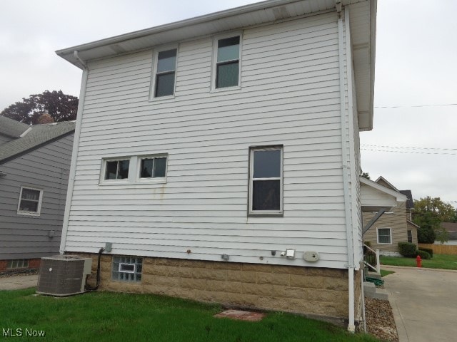 back of house featuring cooling unit