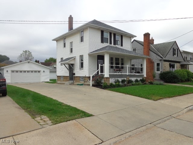 view of front of home with an outdoor structure, a garage, and a porch