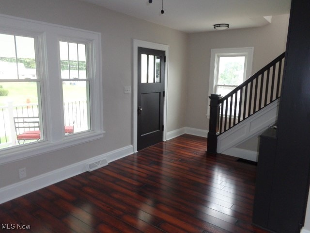 entryway with dark wood-type flooring