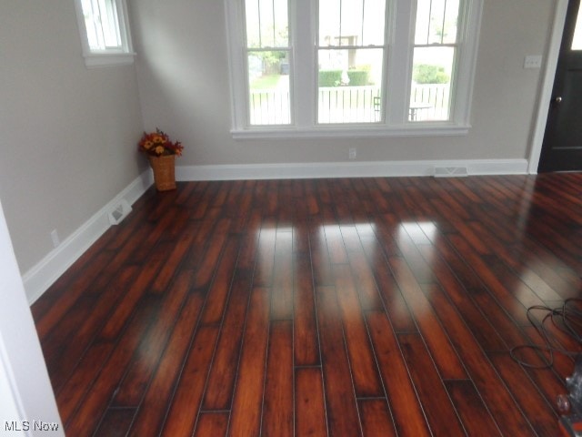 interior space with a healthy amount of sunlight and dark hardwood / wood-style floors