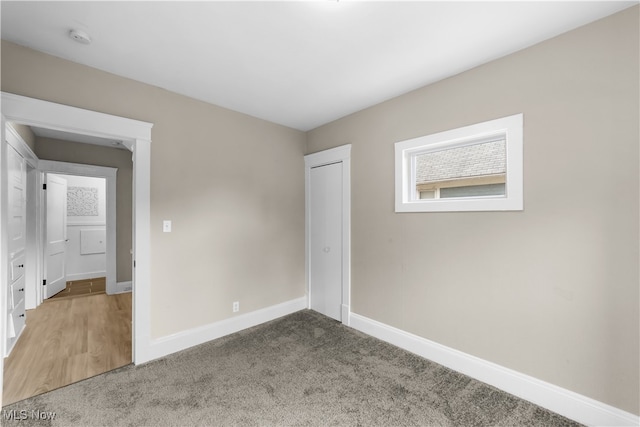 unfurnished bedroom with a closet and carpet floors