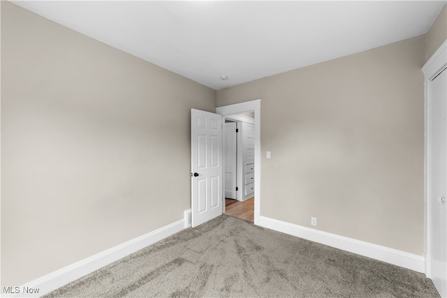 unfurnished bedroom with light colored carpet