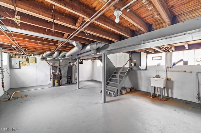 basement with gas water heater and electric panel