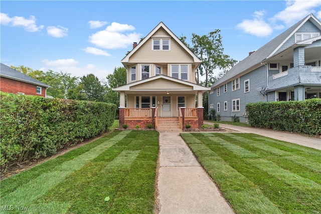 view of front facade with a front yard and covered porch