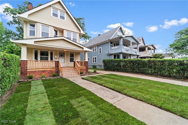 view of front facade featuring covered porch and a front yard