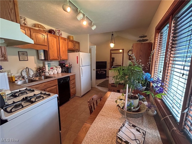 kitchen featuring a textured ceiling, light tile patterned flooring, sink, ventilation hood, and white appliances