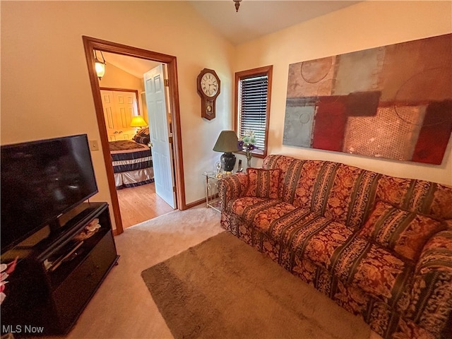 living room featuring light hardwood / wood-style floors and vaulted ceiling