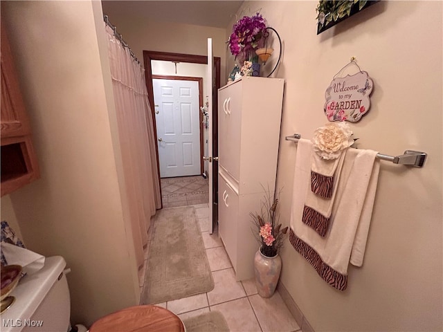 bathroom with toilet and tile patterned flooring