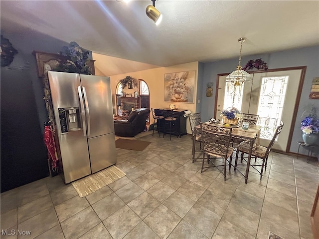 dining room featuring lofted ceiling and a notable chandelier