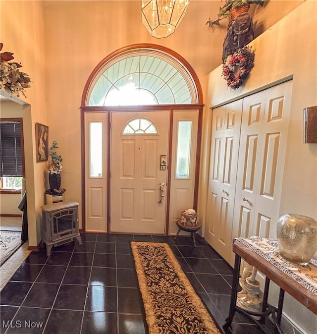 tiled entrance foyer with an inviting chandelier