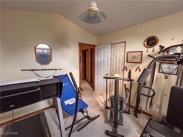 workout area with lofted ceiling, light colored carpet, and ceiling fan