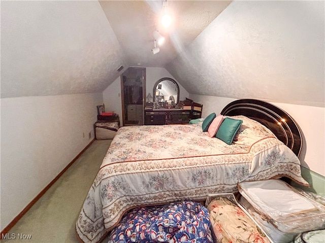 carpeted bedroom featuring vaulted ceiling