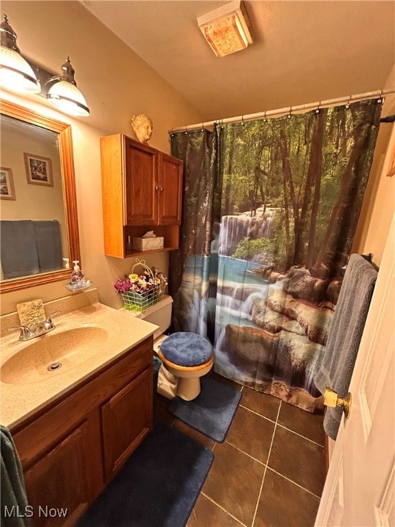 bathroom featuring vanity, toilet, and tile patterned flooring