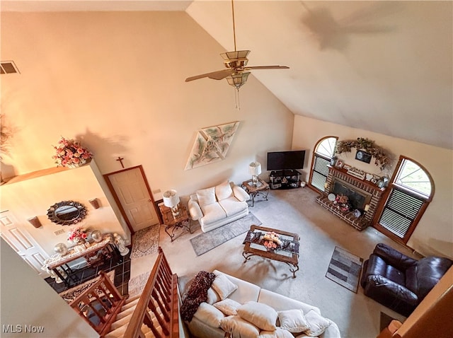 living room featuring a brick fireplace, carpet floors, high vaulted ceiling, and ceiling fan