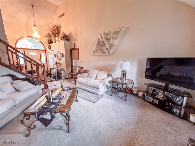 living room with carpet flooring and a high ceiling