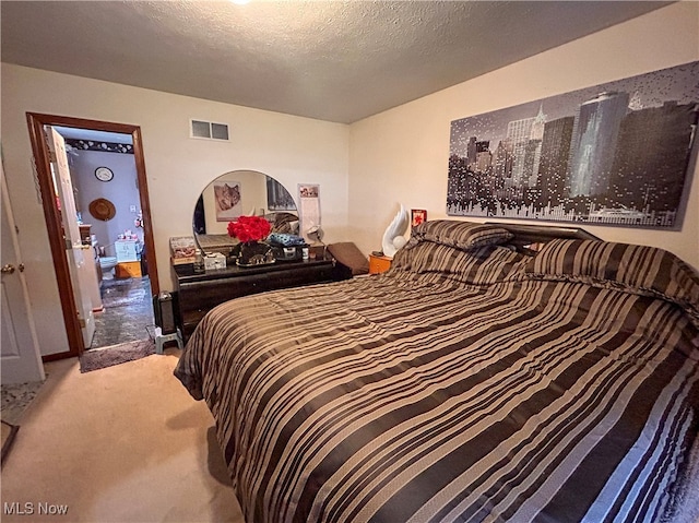 carpeted bedroom featuring a textured ceiling