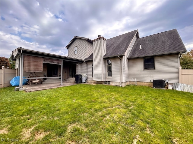 back of house featuring a patio, central AC, and a yard