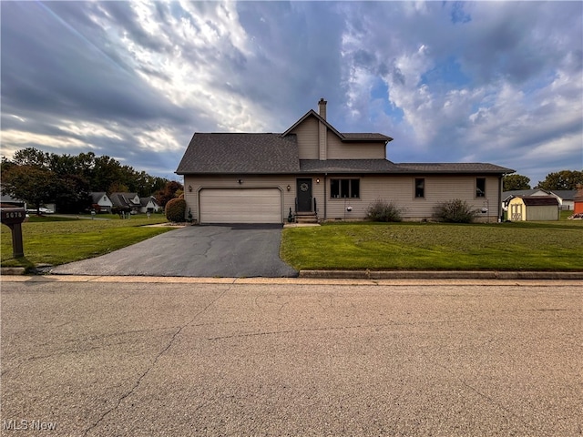 view of front facade with a front yard and a garage