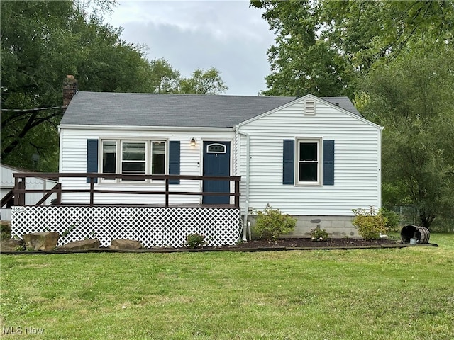 view of front of house with a front yard and a wooden deck