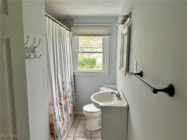 bathroom featuring a textured ceiling, toilet, tile patterned floors, vanity, and curtained shower