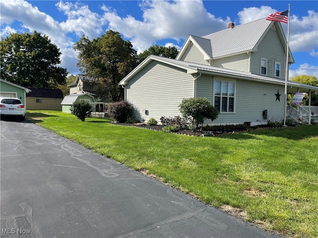 view of side of home featuring a yard