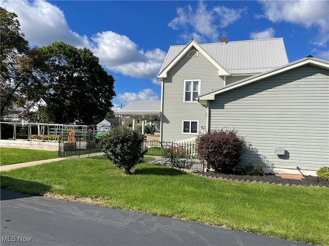 view of side of property with a lawn