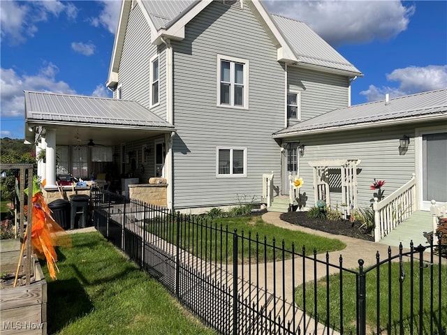 rear view of house with a patio area and a lawn