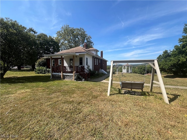 view of front of house with a porch and a front yard