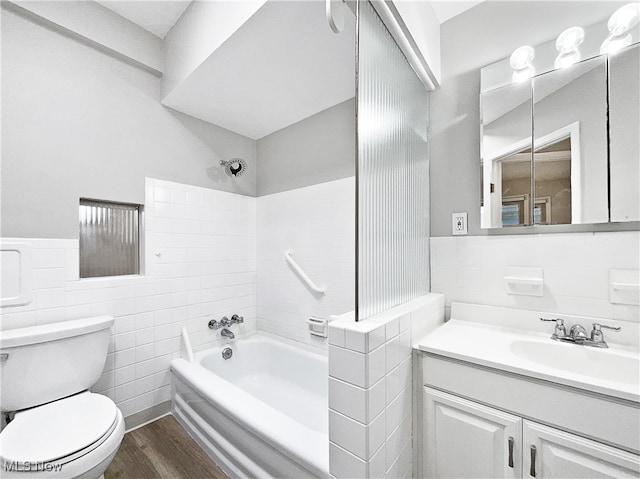 full bathroom featuring vanity, shower / tub combination, hardwood / wood-style flooring, tile walls, and toilet